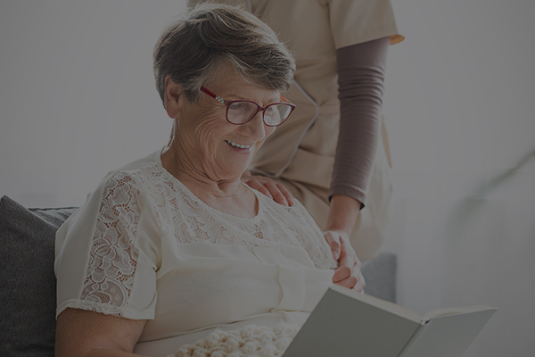 A senior reading to a friend