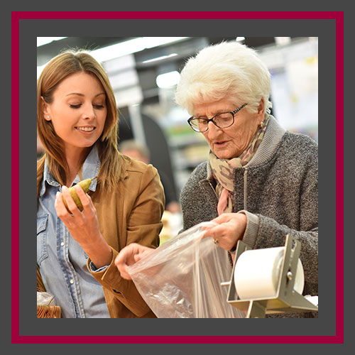 A image of a senior shopping with an assistance professional.