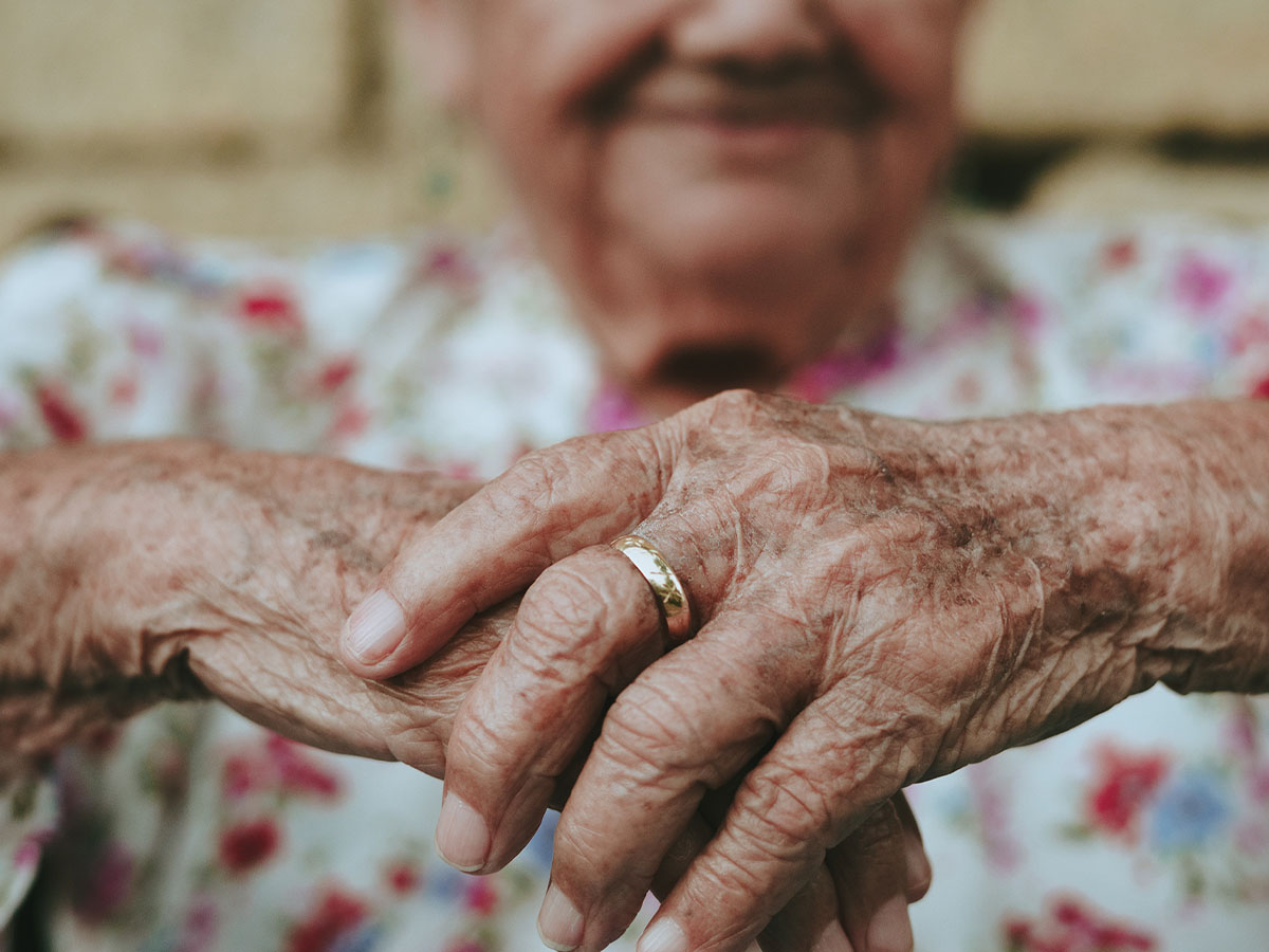 Close up of an elderly person’s hands with the rest of their body blurred in the background