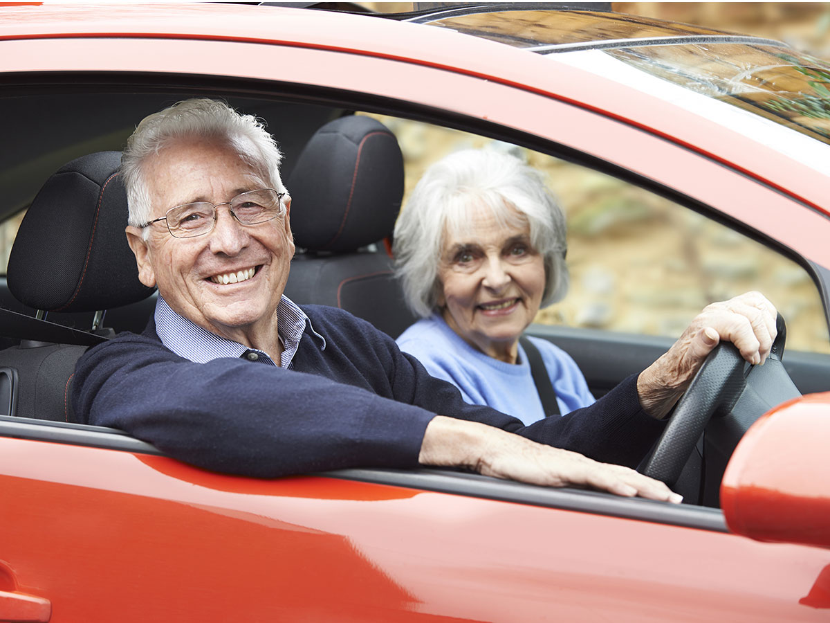 elderly couple in car