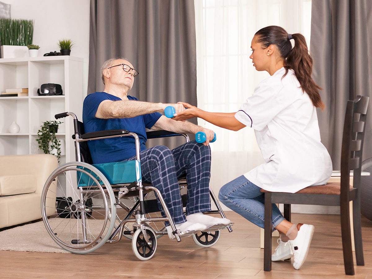Image of a caregiver working with an elderly woman