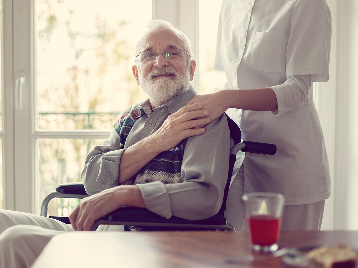 elderly man happy to have caretaker