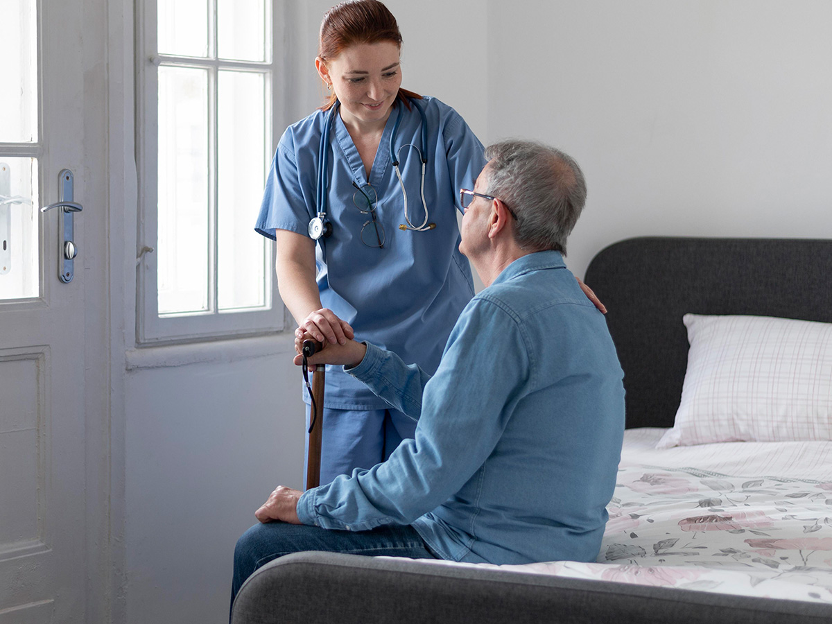 Image of a caregiver working with an elderly man