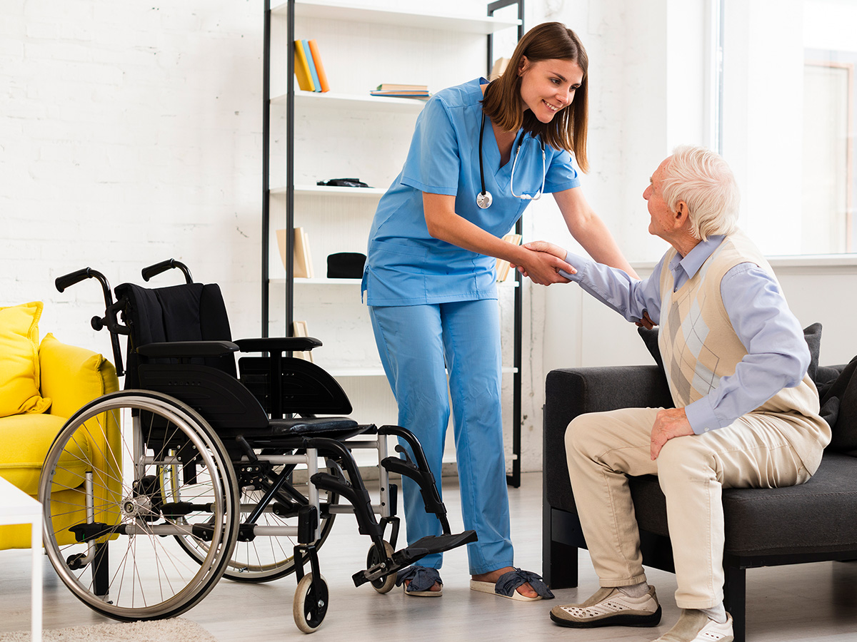 Image of a caregiver working with an elderly man