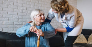 Image of a caregiver working with an elderly woman